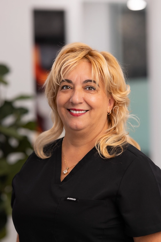Female dental assistant smiling at the clinic reception