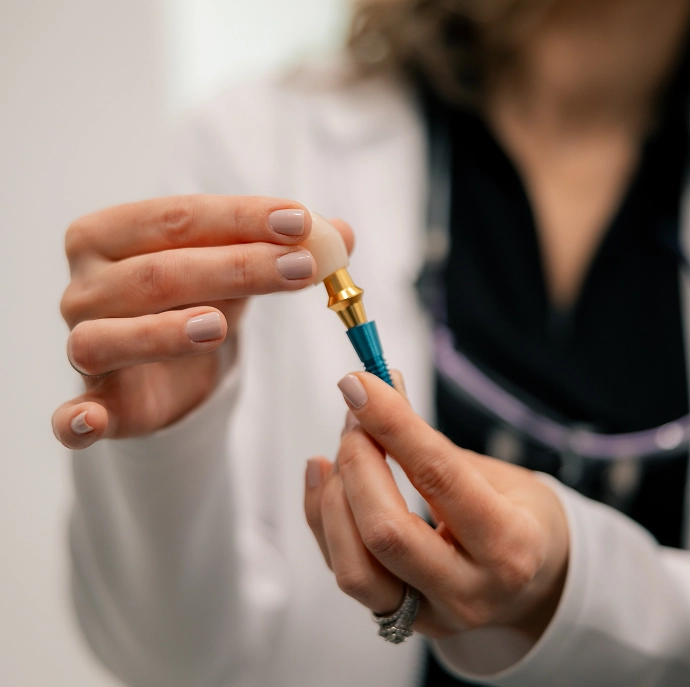 Dr. Yelisbet Fernandez showing dental implant